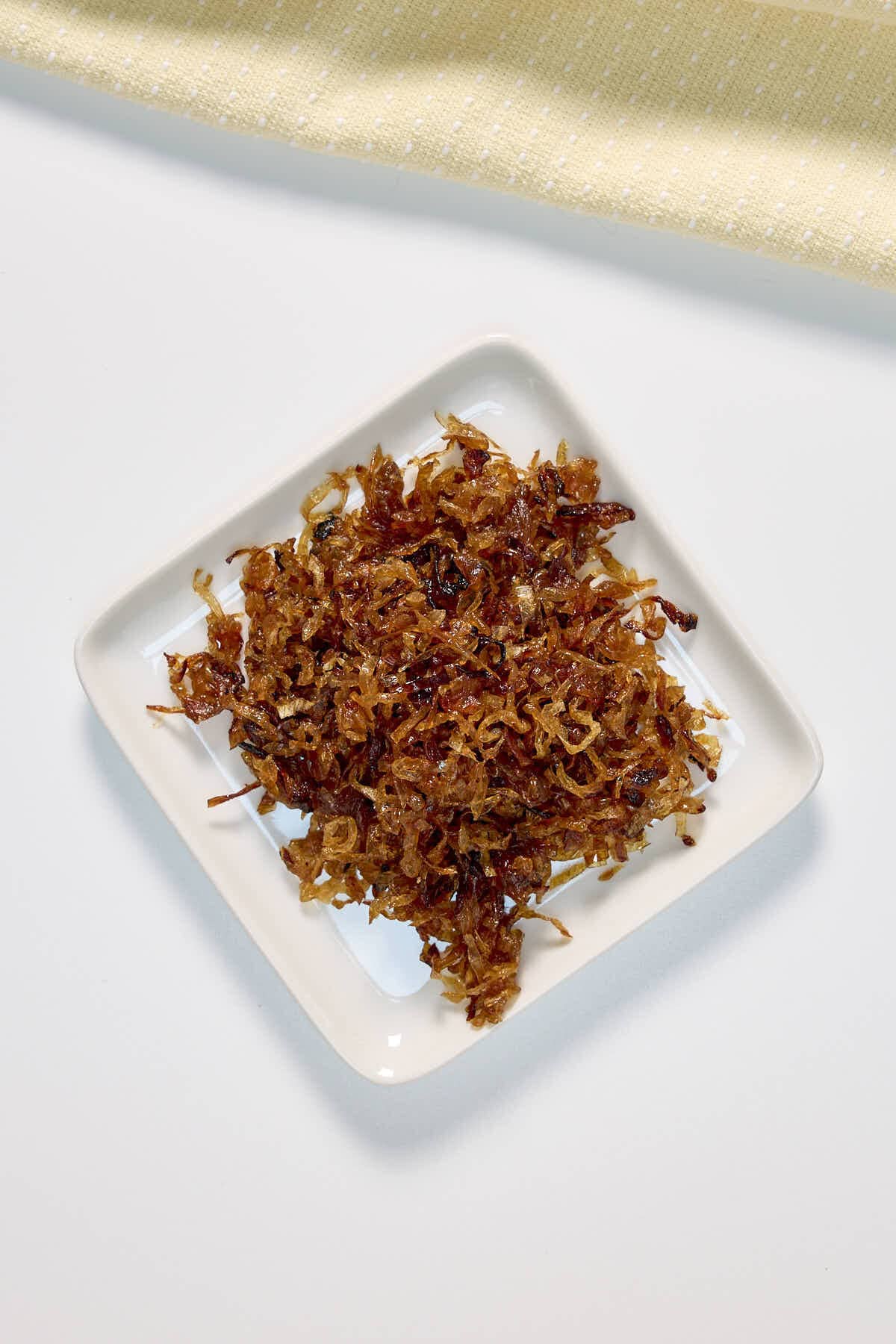 plate of carmelized onions made in the oven on a sheet pan
