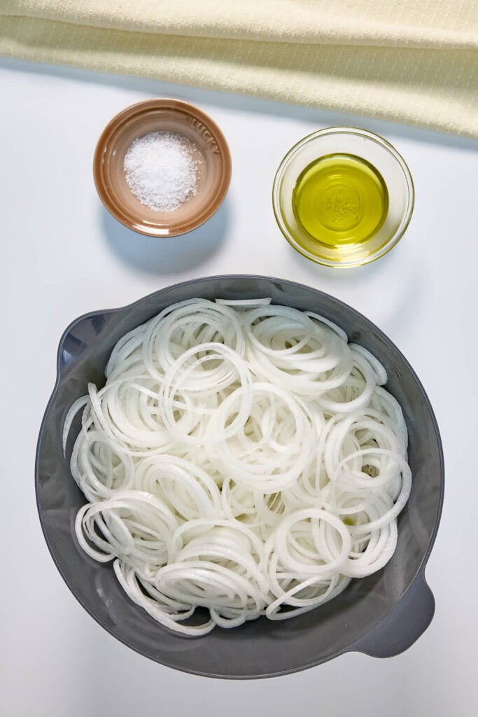 sliced onions, salt, and olive oil