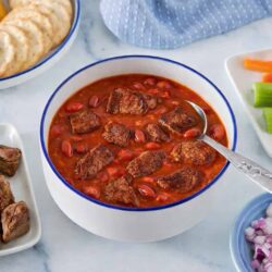 Bowl of chuckwagon chili made with lean stew meat, garnished and served as a high-protein GLP-1 recipe