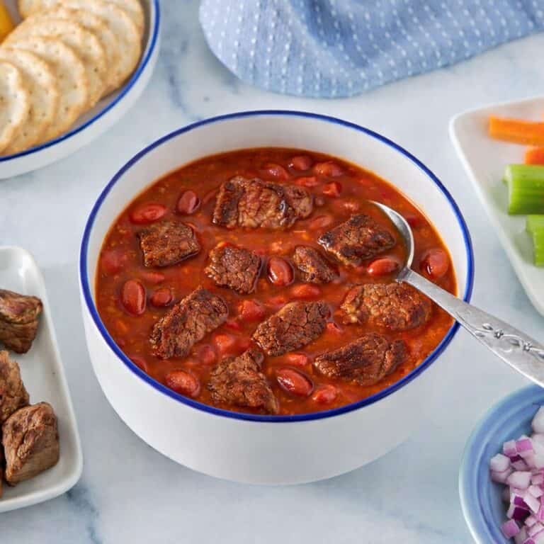 Bowl of chuckwagon chili made with lean stew meat, garnished and served as a high-protein GLP-1 recipe