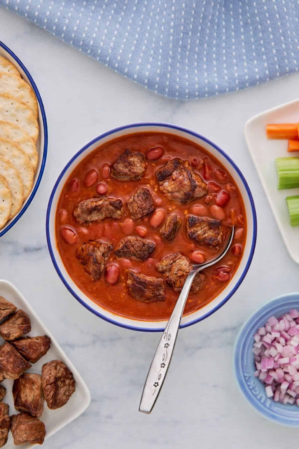 chili with stew meat shown on a table from above