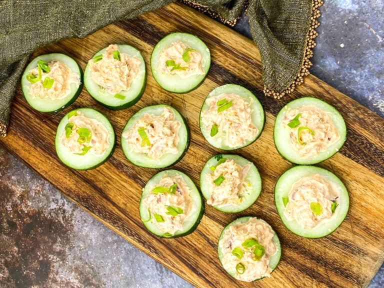 Spicy tuna cucumber bites served on a wood tray