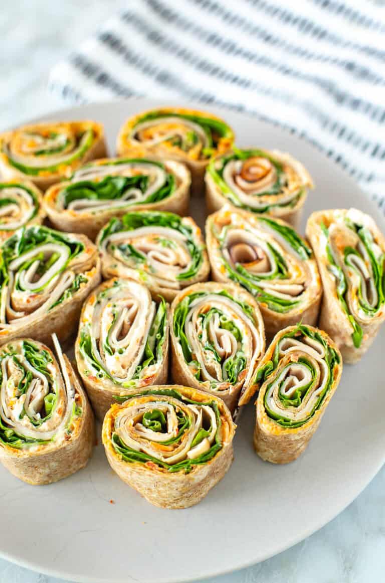 Turkey roll ups sliced and served on a plate