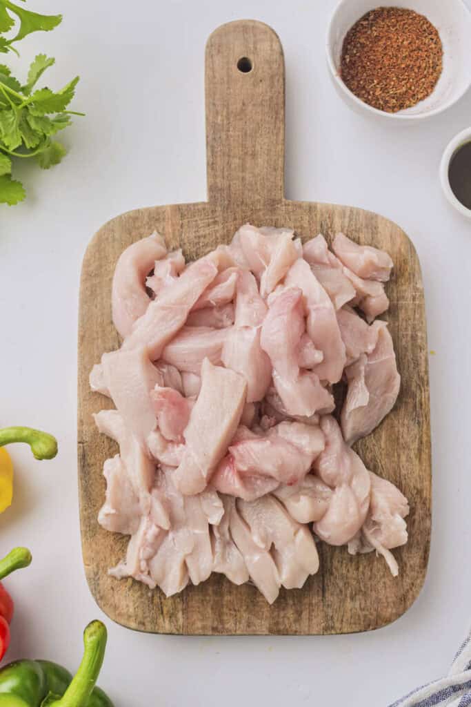 All of the chicken breast strips for this recipe on the cutting board