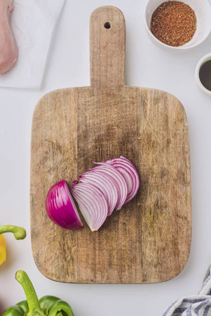 Chopped red onion strips on the cutting board