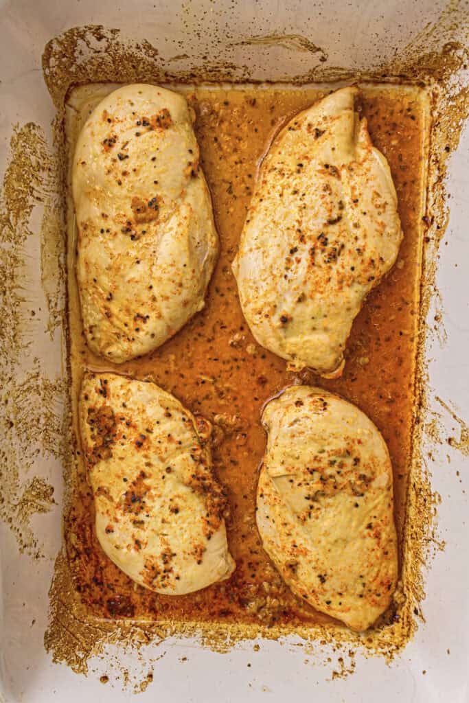 Half cooked chicken breasts ready to be flipped over