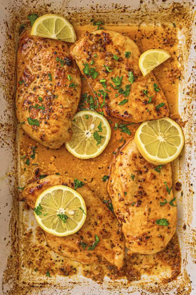 Slices of lemon and chopped herbs added to finish the dish