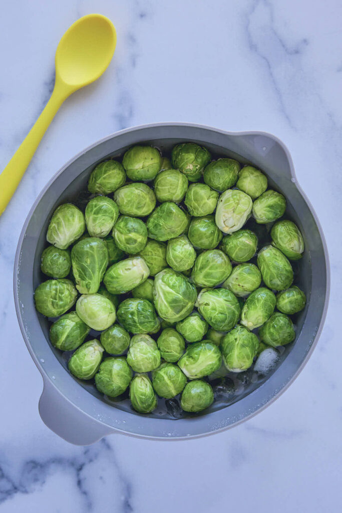 Blanched Brussels sprouts in an ice bath to set the color