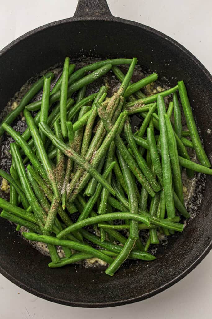 Seasoning on the beans in the skillet