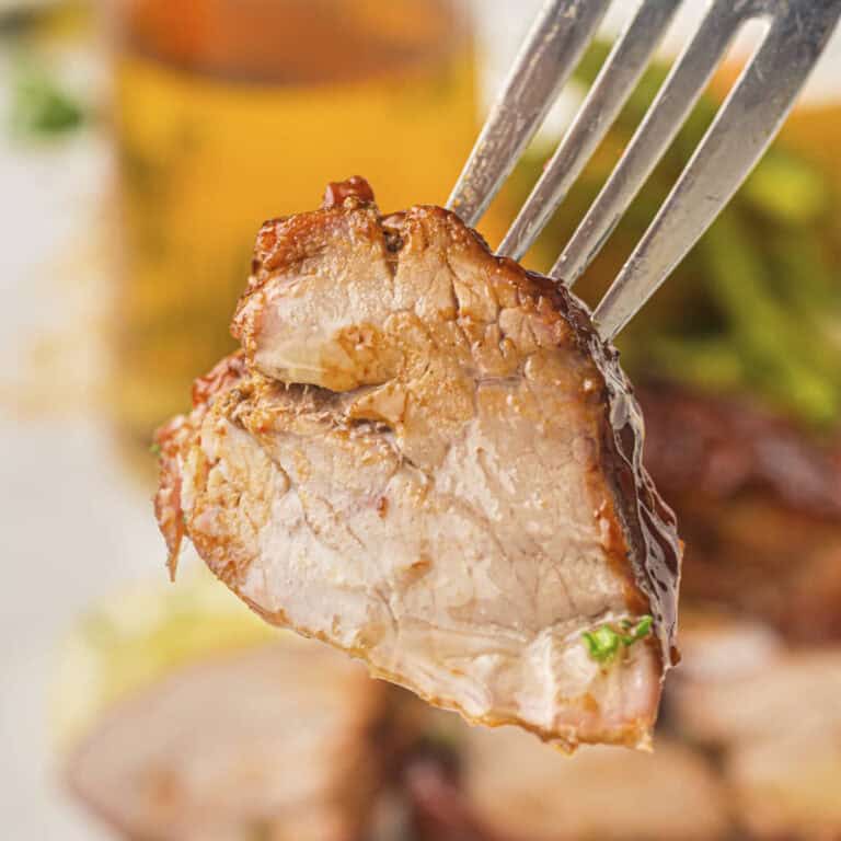 Grilled pork tenderloin from this recipe shown on a fork