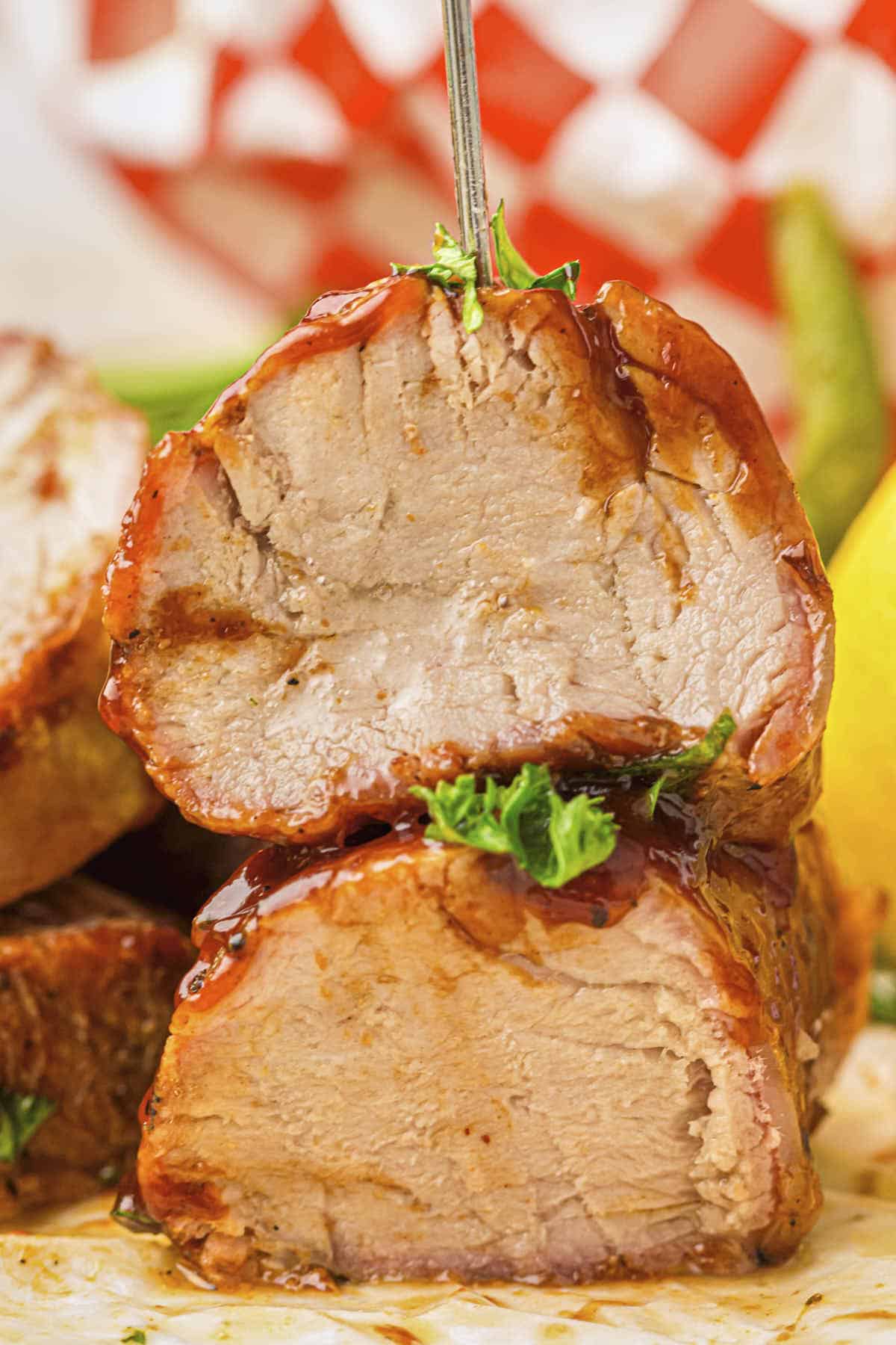 Hero shot of the grilled pork tenderloin plated with BBQ paper in the background