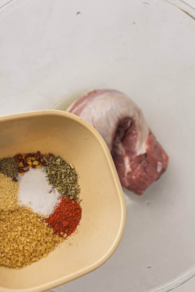 Adding the seasoning to the pork tenderloin