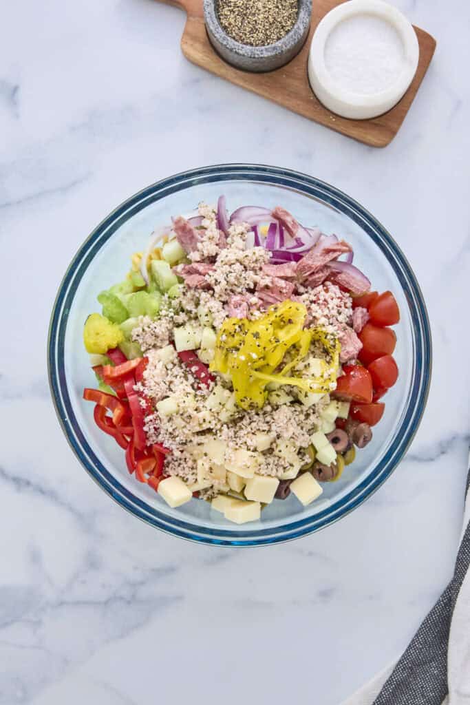 The other ingredients for the pasta salad in the bowl with the protein noodles ready to be tossed