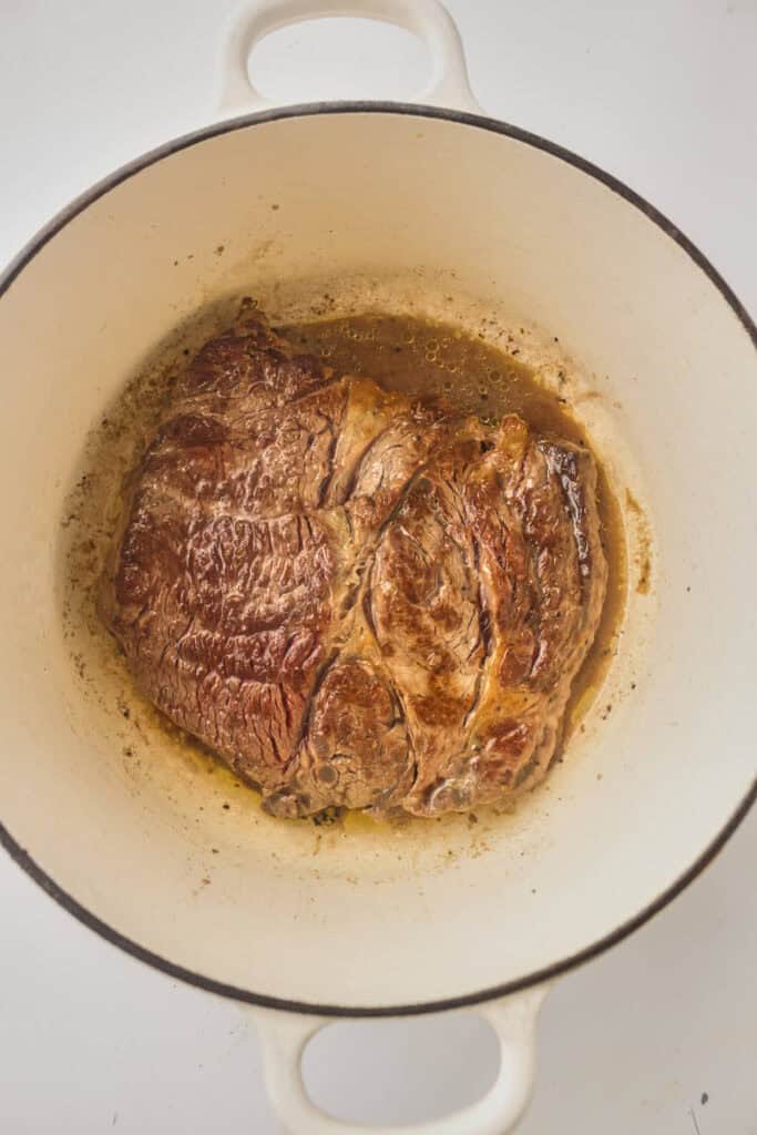 Seared chuck roast in a dutch oven