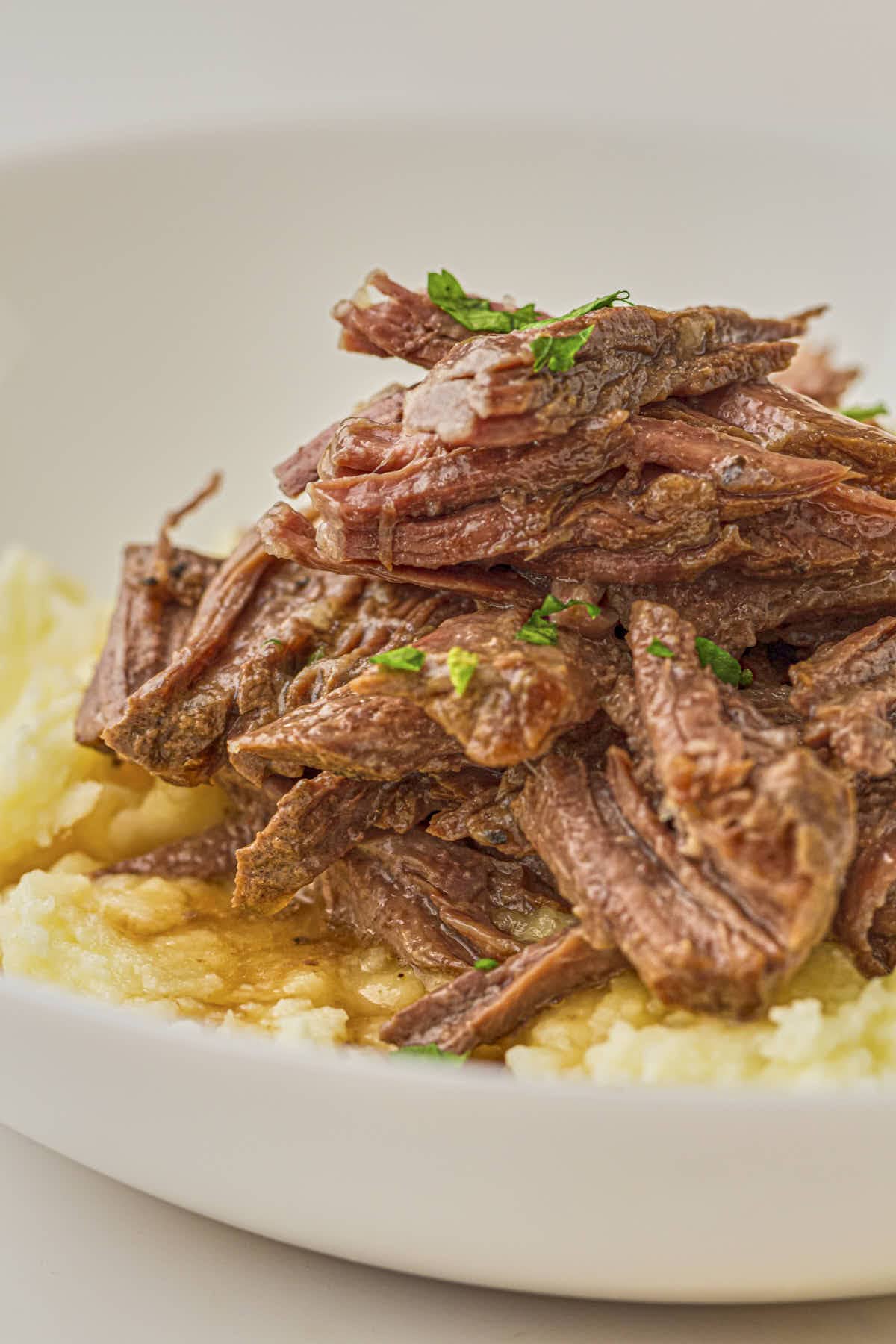 Hero shot of some shredded keto pot roast served with cauliflower puree