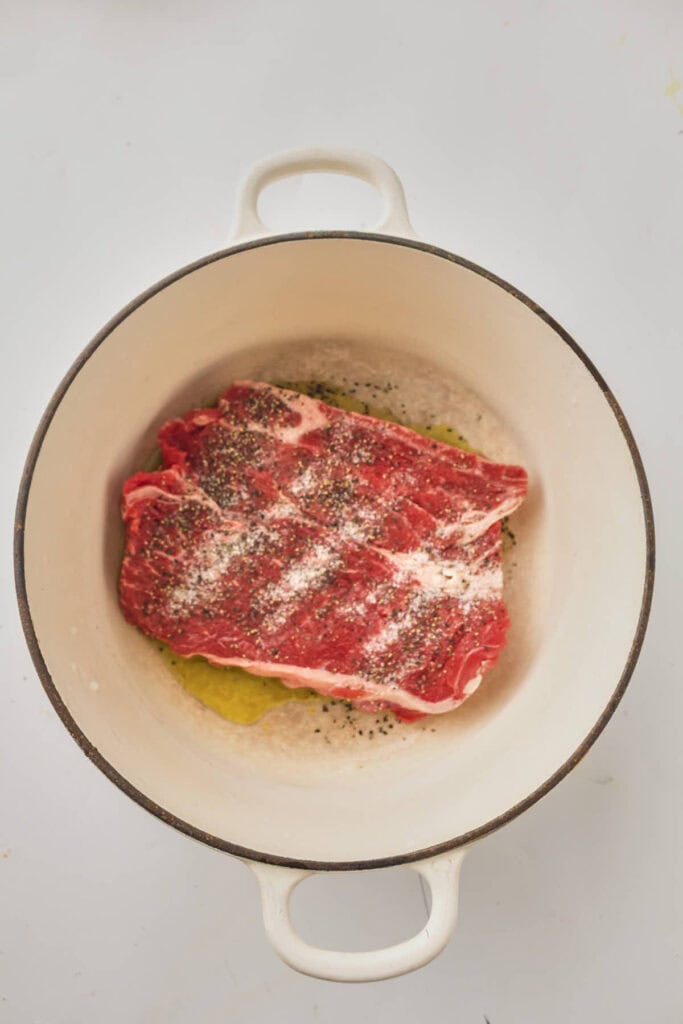 Searing the chuck roast in a dutch oven