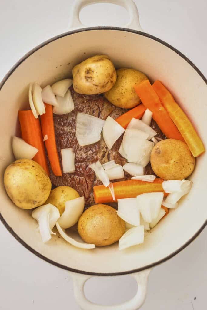 Vegetables added to the chuck roast in the dutch oven, turnips would be added instead to make this a fully keto compliant recipe