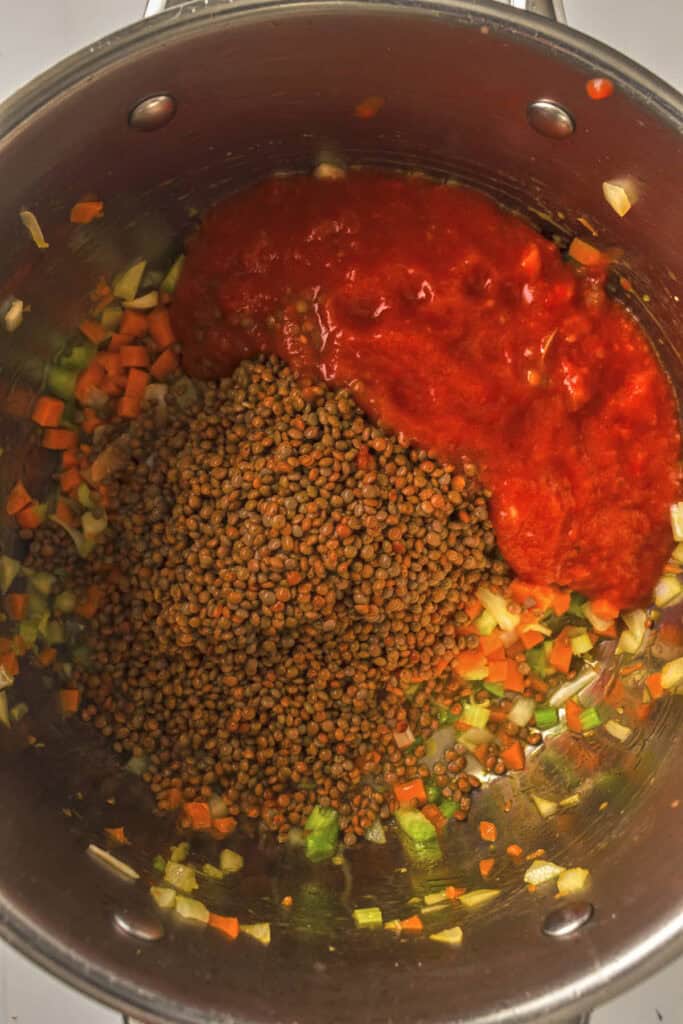 Canned tomato and lentils for the soup added to the pot