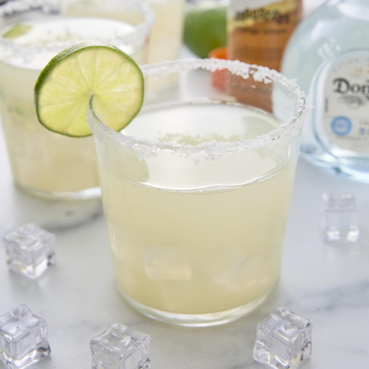 low carb margarita with salt on the rim and garnished with a slice of lime