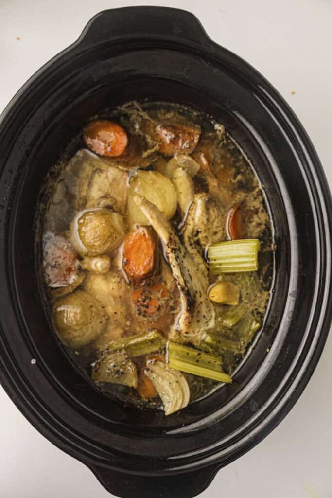 Slow cooker chicken stock that has been cooked in the pot