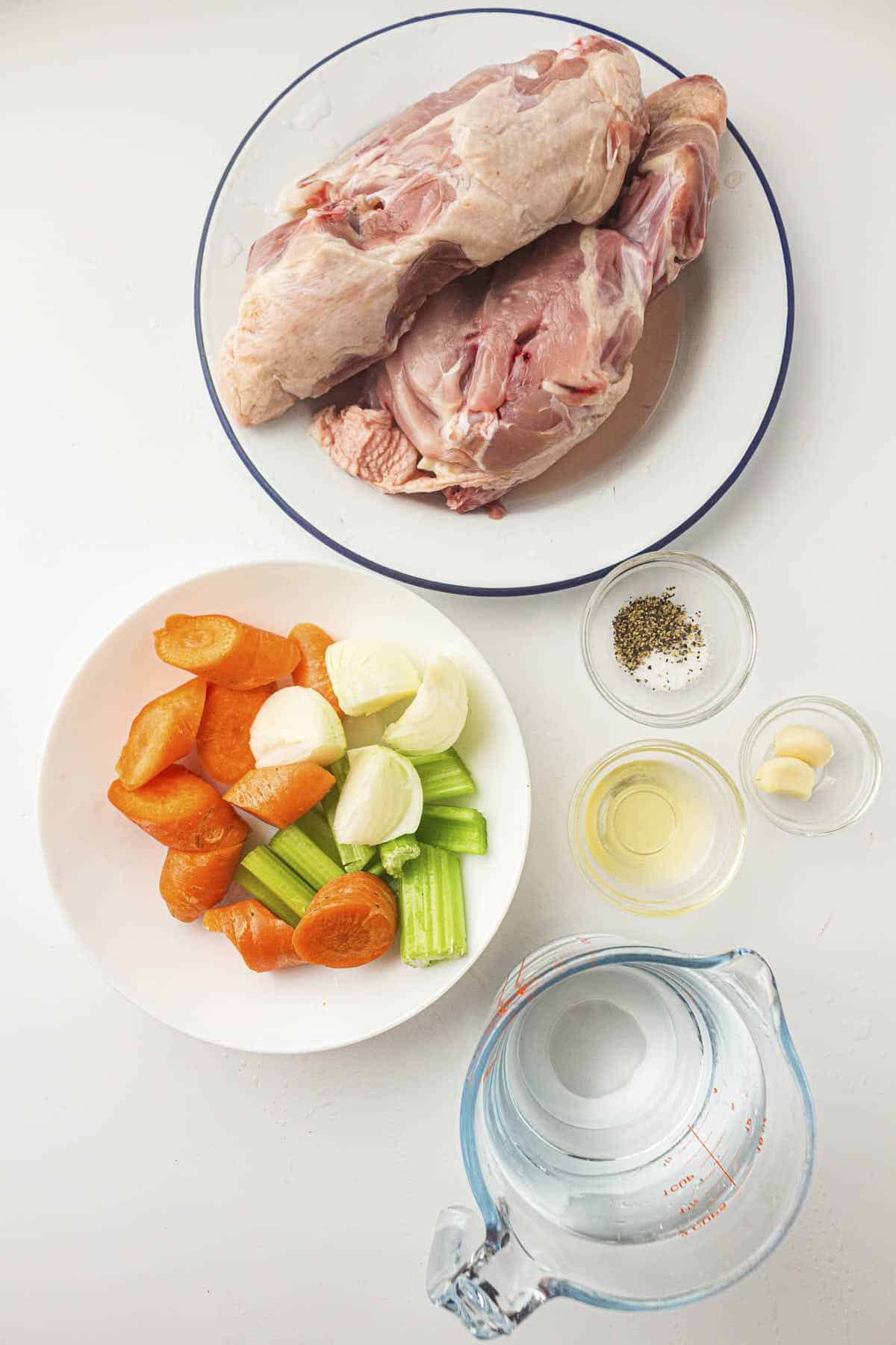 Ingredient photo for the recipe showing uncooked chicken, cut vegetables, cooking wine, and seasoning
