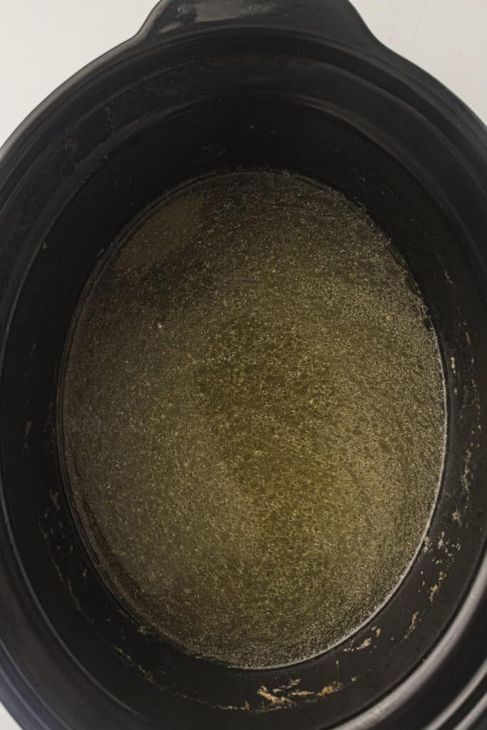 Crockpot of chicken stock with all of the chicken and vegetables removed