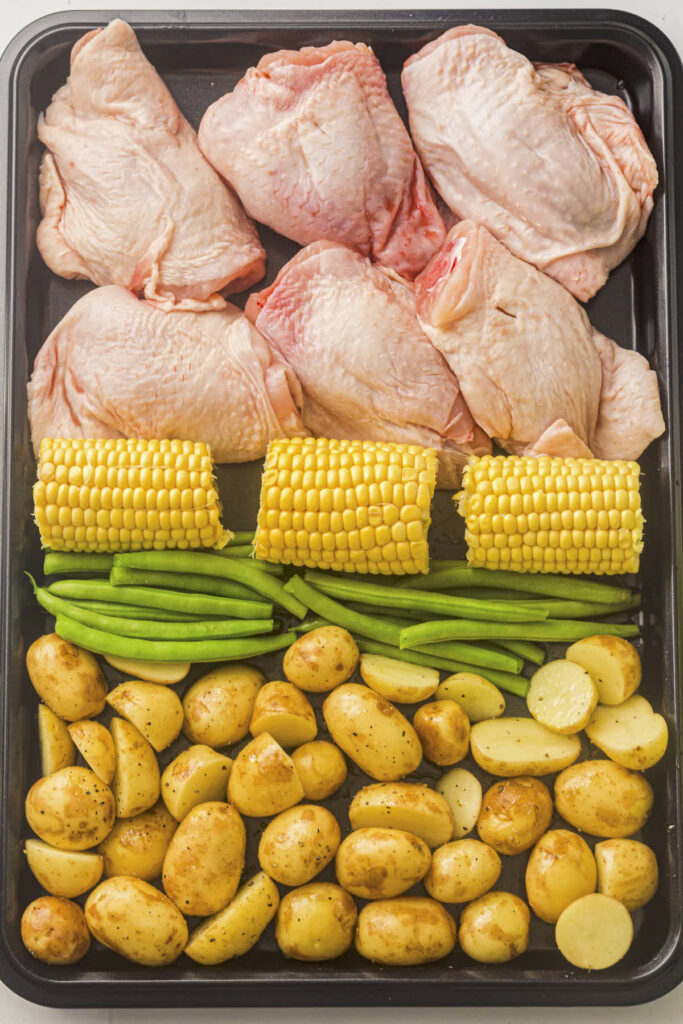 Chicken thighs on the sheet pan with vegetables