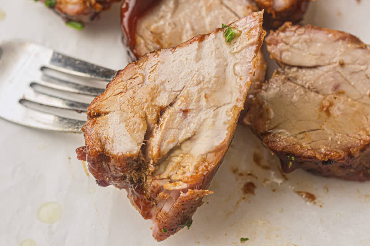 a slice of grilled pork tenderloin on a fork